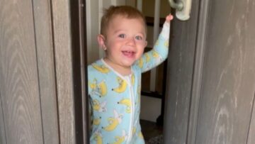 Adorable-Toddler-Surprises-Mom-by-Opening-the-Door-with-a.jpg
