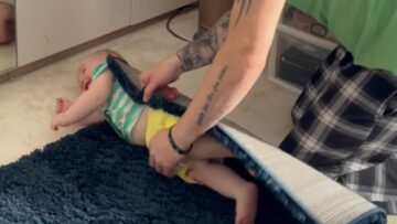Baby-Boy-in-a-Cozy-Rug-Waving-at-Mom-Adorable.jpg