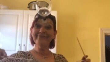 Whimsical-Grandma-Creates-Melodies-with-Wine-Glasses-on-Her-Forehead.jpg