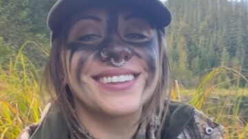 Grizzly-Bear-Joyfully-Plays-with-a-Tree-Branch-in-Heartwarming.jpg